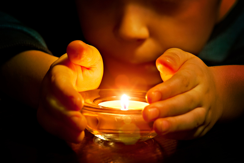 Child and candle light